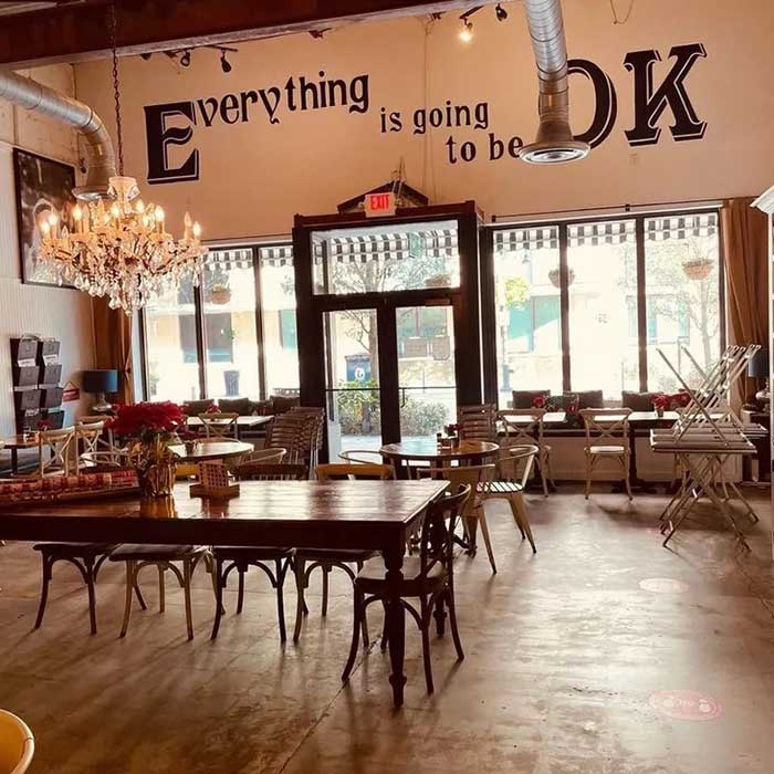 field of greens healthy food restaurant, downtown west palm beach: photo shows interior of restaurant. Everything is going to be OK is written in a fun typeface on the wall above the entrance doors.