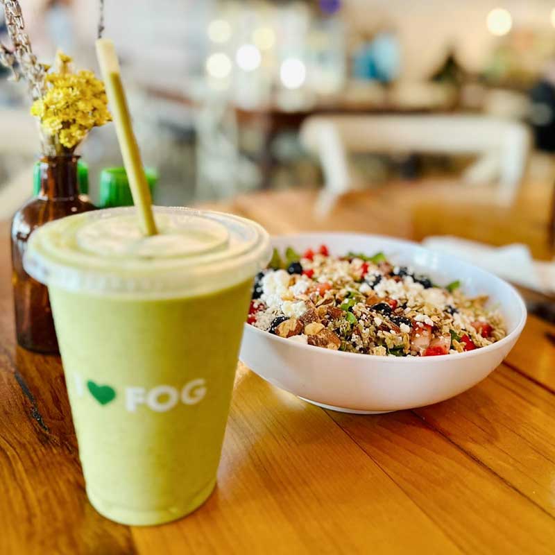 field of greens health food restaurant, phillips point - photos of smoothie and acai bowl on a table.