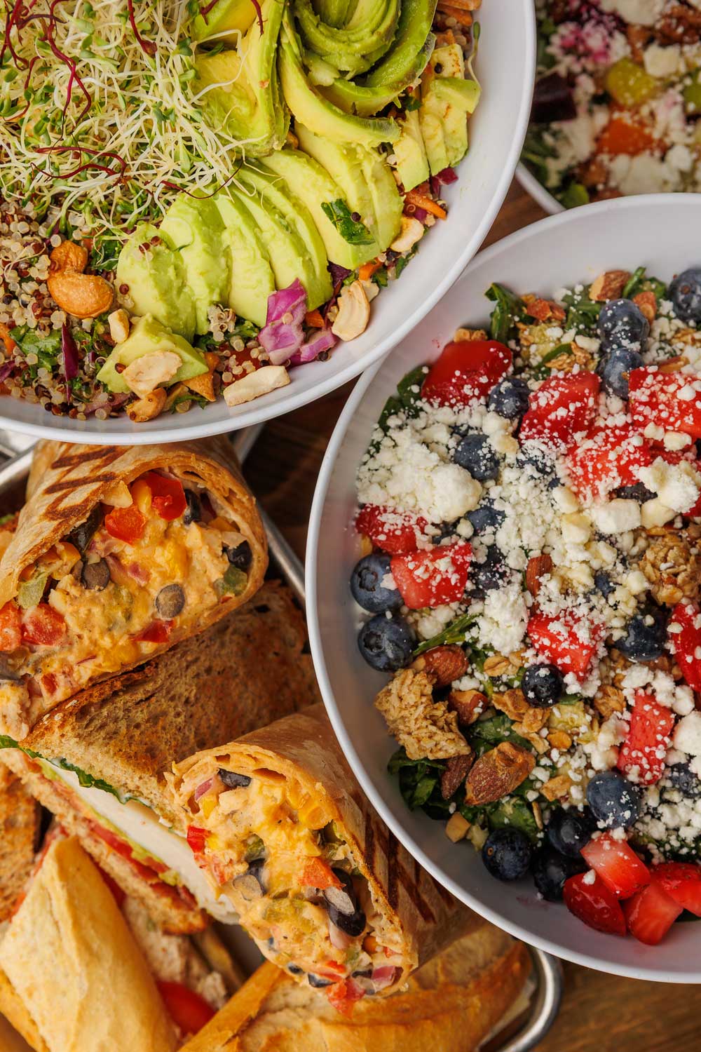 grouping of sandwiches and bowls arranged near one another