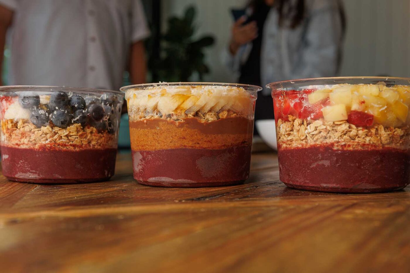 Our healthy breafkast and lunch cafe menu features acai bowls: three are shown in this photo, positioned side by side.